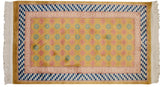Blush and light blue floral field, stacked blue cube border of a vintage Art Deco rug.