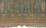 The even, full pile and ivory fringe of a hand-knotted Bulgarian Kerman carpet.