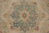 Detail of the starburst center medallion in seafoam green, dusty raspberry red, and gold.