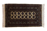 Vintage Indian Bokhara rug with double elephant footprint guls, dark cherry red, navy, and cream.