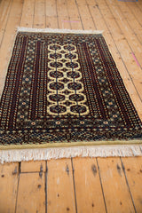 Intricate geometric border with snowflake finned relief, black cherry, navy, and cream fringe.