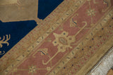 Dusty rose Samovar border and navy field on a vintage Indian Serapi rug corner.