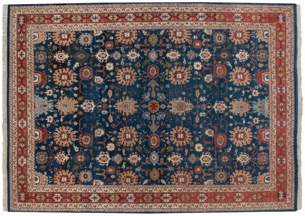 Vintage Indian Sultanabad carpet with large-scale palmettes on a blue field, framed by a brick red border.