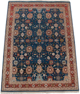 Angled view of a vintage Sultanabad carpet showing its large palmettes and brick red border.