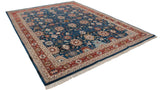 Angled view of a vintage Indian Sultanabad carpet with an allover palmette design and red border.