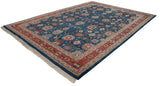 The entire vintage Indian Sultanabad carpet laid flat and viewed from a side angle.