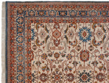 Corner detail of a vintage Indian carpet showing the palmette and arabesque border and fringe.
