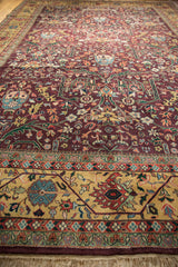 Vintage Bijar rug's fringe, gold meandering vine border, and floral gul ferang field.
