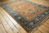 Navy meandering vine border and orange gul ferang rose florals on vintage Indian Bijar.