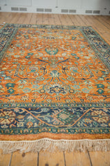 Hand-knotted Indian Bijar rug, orange-rust field with blue gul ferang motifs and fringe.