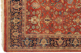 Close-up on the navy blue border and terracotta field showing the full pile of a vintage Indian Mahal carpet.