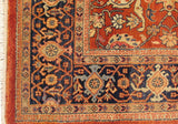 Corner of a vintage Mahal carpet showing the navy blue border with turtle motifs and full pile.