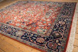 Hand knotted vintage Indian Bijar carpet's rust field, scrolling rose florals, navy border.