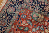 Vintage Indian Bijar carpet featuring rust field, navy vine border, and scrolling rose florals.