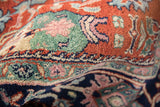 Textured hand-knotted pile showing Bijar gul ferang motif in rust, navy, mallard green, and pink.