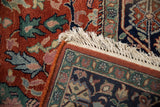 Hand knotted Indian Bijar design carpet with rust floral field, navy meandering border, and ivory fringe.