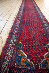 Angled perspective showing the full length of the vintage red and blue Tajabad runner.