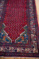 Intricate red boteh field meets the sapphire blue corner on this hand-knotted vintage Persian runner.