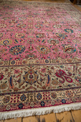 Corner view of a vintage Tabriz rug with an intricate floral border and clean ivory fringe.