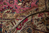 Lush, full pile of a vintage Persian Tabriz rug with intricate pink and wine red floral details.