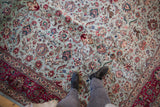 Detailed view of a vintage Tabriz rug's full pile and forest theme with prancing deer.