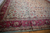 Raspberry red border with floral and animal motifs on a vintage silver-blue Tabriz square carpet.