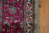 A prancing deer motif and intact side cord selvage on a vintage Tabriz rug.