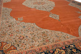 Angled view of the carpet's silver corner spandrel and floral vinery against the burnt orange field.