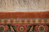 Detail of the vintage Bulgarian carpet's intact ivory fringe and subtle repiling on the terra cotta border.