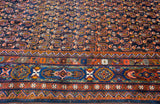 Paneled cartouches featuring bird and serpent motifs on an antique Persian Afshar rug's main border.