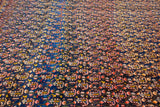 A close perspective of the antique Afshar carpet's allover field of alternating botehs on a navy blue ground.