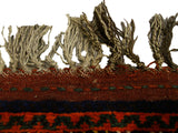 Original secured kilim end with coarse, hand-knotted fringe on an antique Afshar carpet.