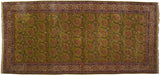 Vintage Kerman carpet with a rare green field filled with rose floral bouquets and an intricate border.