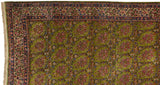 Intricate floral borders and original side cord selvage on a vintage Persian Kerman's green field.