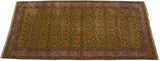 Angled perspective of a collector's vintage Kerman carpet with its allover pattern of rose bouquets on a rare green field.