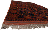 Corner view of a vintage Taghan rug showing its dense pile, secured end, and original fringe.