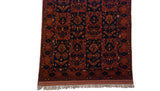 The fully secured end and original ivory fringe on a vintage hand-knotted Pakistani Taghan rug.
