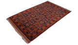 High-angle view of a vintage Taghan rug with paneled tree of life motifs in chestnut and navy blue.