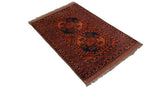 Fringe and diamond lattice border of a vintage Ersari rug in chestnut brown and navy.
