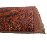 Vintage Ersari rug with chestnut and navy geometric gul motifs, original side selvage, Kilim fringe.