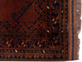 Vintage Ersari rug corner: geometric gul motif, chestnut, navy, intact selvage and fringe.