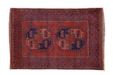 Vintage Pakistani Ersari rug with geometric elephant foot guls in madder root and navy blue.