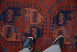 View from above showing the full pile and geometric elephant footprint motif of a vintage Pakistani rug.