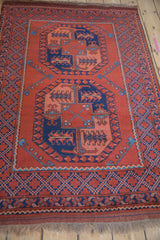 Geometric diamond lattice border and short fringe at the end of a vintage Pakistani Ersari rug.