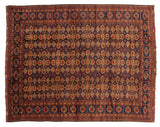Vintage Taghan carpet corner, featuring navy blue, madder red geometric floral motifs.