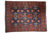 Vintage Pakistani Taghan carpet, oversized floral and boteh pattern in dark copper and navy blue.