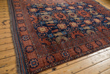 Corner of vintage Taghan carpet: navy blue and dark copper geometric border, with original selvage.