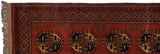 Ersari runner corner, displaying fringe and chestnut, navy, pistachio geometric border pattern.