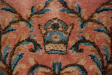 European Rococo motif detail in sky blue on the plush, dusty rose pile of a fine vintage Kerman carpet.
