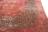 Oversized scrolling vine border in European Rococo style on a dusty rose Kerman carpet.